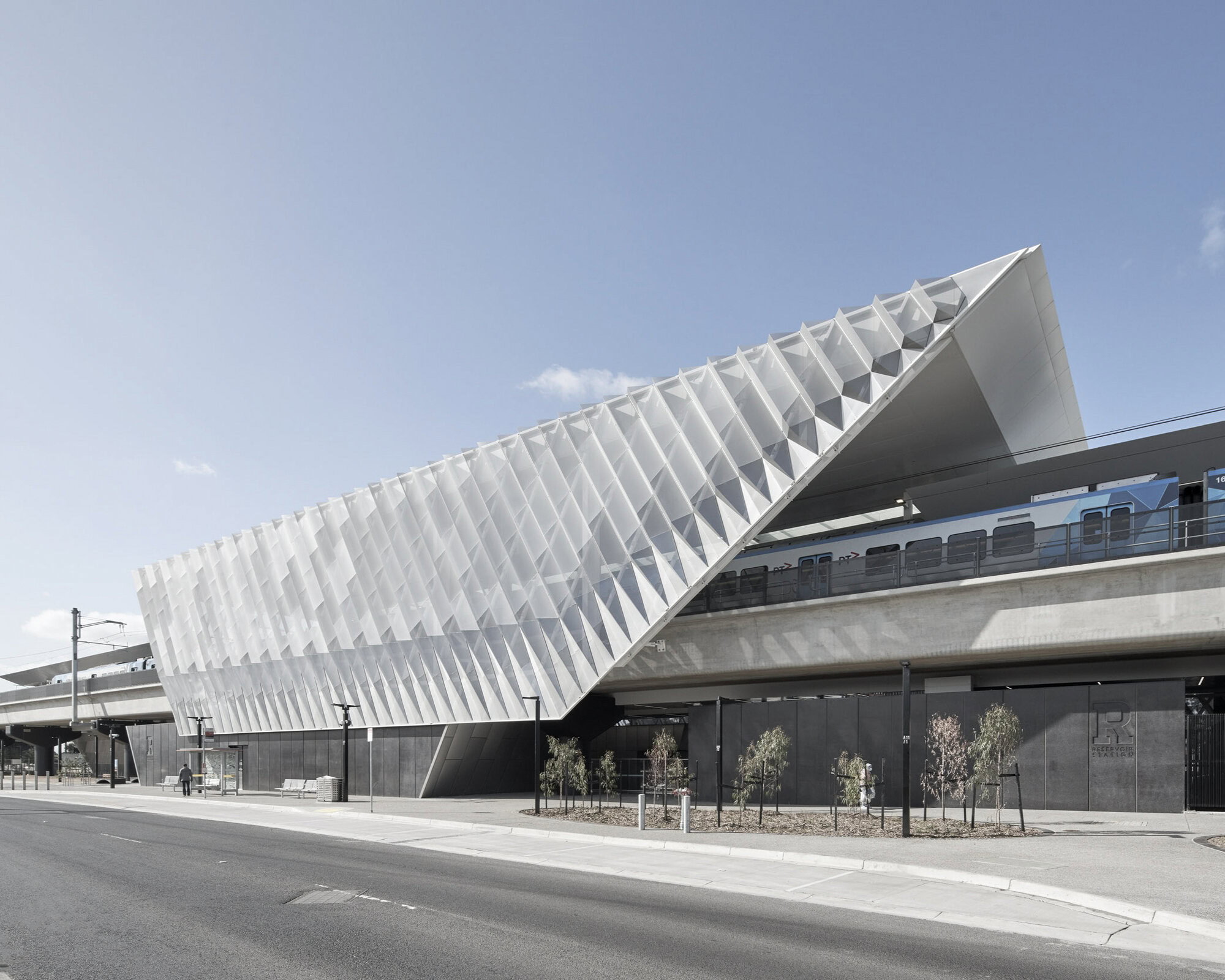 Reservoir Station by Genton – angular mesh façade and elevated rail design by one of the best rail architects in Australia.